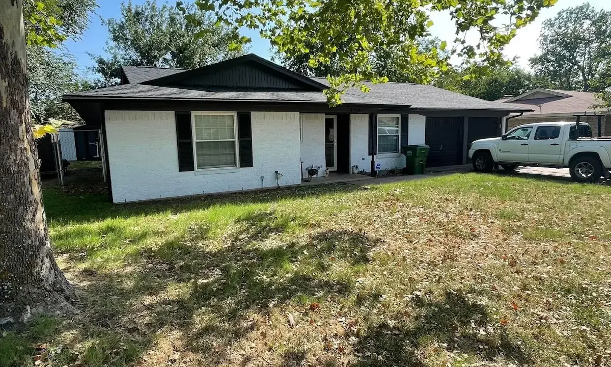 Professional roofing crew working on a residential roof in East Greenwich